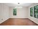 Bright dining room featuring wood floors, modern lighting and large windows with outside view at 1920 Rocky Mill Ln, Lawrenceville, GA 30044