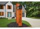 Beautiful two-story home with address marker and lush green lawn, gray roof, an attached two-car garage at 1920 Rocky Mill Ln, Lawrenceville, GA 30044