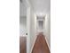 Neutral hallway with hardwood floors and doors leading to other rooms at 1920 Rocky Mill Ln, Lawrenceville, GA 30044