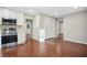Open kitchen with white cabinets, stainless steel appliances, recessed lighting, and wood flooring at 1920 Rocky Mill Ln, Lawrenceville, GA 30044