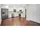 Modern kitchen featuring stainless steel appliances, white cabinets, granite countertops, and hardwood floors at 1920 Rocky Mill Ln, Lawrenceville, GA 30044