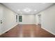 Bright living room featuring wood floors, recessed lights and large windows with a connecting doorway at 1920 Rocky Mill Ln, Lawrenceville, GA 30044