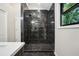 Modern shower featuring dark tile and contrasting grout, with a window view at 1920 Rocky Mill Ln, Lawrenceville, GA 30044