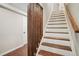 Wooden staircase with white risers and wood railing, and a decorative wood element at 1920 Rocky Mill Ln, Lawrenceville, GA 30044