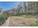 Grassy backyard offers mature trees and is partially fenced in at 3619 Elinburg Ne Ct, Buford, GA 30519