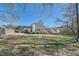 Large backyard with mature trees offers ample space to enjoy outdoor activities at 3619 Elinburg Ne Ct, Buford, GA 30519