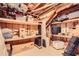 Unfinished basement area with wooden beam ceiling, storage shelves, and belongings, a perfect space to customize at 3619 Elinburg Ne Ct, Buford, GA 30519