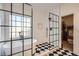 A bright bathroom features a freestanding tub, an enclosed shower, and black and white checkerboard tile at 3619 Elinburg Ne Ct, Buford, GA 30519