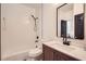 A bathroom with a tub, wood vanity, a toilet, and modern fixtures at 3619 Elinburg Ne Ct, Buford, GA 30519