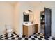 Stylish bathroom with black and white tile flooring, double sink vanity, and modern fixtures at 3619 Elinburg Ne Ct, Buford, GA 30519