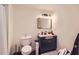Modern bathroom featuring a sleek vanity, stylish lighting, and a framed mirror at 3619 Elinburg Ne Ct, Buford, GA 30519