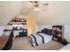 Bedroom with sloped ceilings, built-in shelving, desk space, and natural light at 3619 Elinburg Ne Ct, Buford, GA 30519