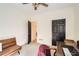 Bedroom features dark wood ceiling fan, furniture, and a brown leather couch at 3619 Elinburg Ne Ct, Buford, GA 30519