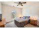 Calm bedroom with a large window, dresser, and matching bedside tables with lamps at 3619 Elinburg Ne Ct, Buford, GA 30519