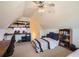 The attic bedroom features a desk, a bed, and recessed shelving at 3619 Elinburg Ne Ct, Buford, GA 30519