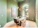 Bright dining room featuring pale wood floors, sage green walls, and high ceilings at 3619 Elinburg Ne Ct, Buford, GA 30519