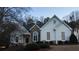 Elegant exterior view showcasing a two-story home with stone accents and well-maintained landscaping at 3619 Elinburg Ne Ct, Buford, GA 30519