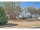 Charming single Gathering home with a stone-accented facade, mature trees, and a well-manicured lawn at 3619 Elinburg Ne Ct, Buford, GA 30519