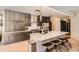 Contemporary kitchen featuring an island with seating, sleek countertops, and stainless steel appliances at 3619 Elinburg Ne Ct, Buford, GA 30519