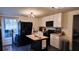 Modern kitchen with black appliances, a butcher block island and great natural light at 3619 Elinburg Ne Ct, Buford, GA 30519