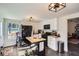 Bright kitchen featuring an island, modern lighting, appliances and access to another room at 3619 Elinburg Ne Ct, Buford, GA 30519