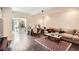 Inviting living room featuring comfortable seating, a stylish rug, and an adjacent office space at 3619 Elinburg Ne Ct, Buford, GA 30519