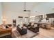 Spacious living room featuring a vaulted ceiling, hardwood floors, and large windows with natural light at 3619 Elinburg Ne Ct, Buford, GA 30519