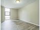 Bright bedroom with light gray vinyl flooring and a window offering views of the neighborhood at 620 Peachtree Ne St # 1413, Atlanta, GA 30308
