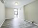 A bright bedroom featuring light gray vinyl flooring and a window to a balcony at 620 Peachtree Ne St # 1413, Atlanta, GA 30308