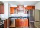 Kitchen featuring dark cabinets, granite countertops, and stainless steel refrigerator at 620 Peachtree Ne St # 1413, Atlanta, GA 30308