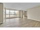 Bright, open living room with wood floors and city views from the balcony at 620 Peachtree Ne St # 1413, Atlanta, GA 30308