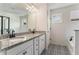 Elegant main bathroom featuring a double sink vanity, granite counters, and black hardware at 847 Venture Sw Way, Atlanta, GA 30331