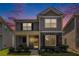 Charming two-story home with stone accents and well-maintained landscaping at dusk at 847 Venture Sw Way, Atlanta, GA 30331