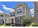 Two-story home with gray siding, stone accents, a covered porch, and established landscaping at 847 Venture Sw Way, Atlanta, GA 30331