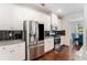 Modern kitchen with stainless steel appliances, granite countertops, and stylish black backsplash at 847 Venture Sw Way, Atlanta, GA 30331