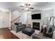 Bright living area featuring a fireplace, ceiling fan, wood floors, and comfortable seating at 847 Venture Sw Way, Atlanta, GA 30331