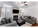 Cozy living room features a fireplace, plush seating, and a ceiling fan for year-round comfort at 847 Venture Sw Way, Atlanta, GA 30331