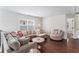 Bright living room boasts hardwood floors, large sectional sofa, and stylish decor at 847 Venture Sw Way, Atlanta, GA 30331