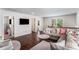 Open-concept living room featuring a plush sofa and seamless flow to adjacent rooms at 847 Venture Sw Way, Atlanta, GA 30331