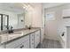 Elegant main bathroom features dual sinks, granite counters, and modern fixtures at 847 Venture Sw Way, Atlanta, GA 30331