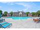 Well-maintained community pool with ample seating and a clubhouse in the background at 847 Venture Sw Way, Atlanta, GA 30331