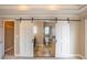 Spa-like bathroom with tiled floor, soaking tub, and separate shower, accessed through sliding barn doors at 1137 Fortress Sw Ave, Atlanta, GA 30315