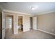 A spacious bedroom with neutral carpet, featuring a closet and ensuite bathroom entrance at 1137 Fortress Sw Ave, Atlanta, GA 30315