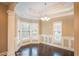 Bright dining room with elegant chandelier, decorative trim, and hardwood floors at 1137 Fortress Sw Ave, Atlanta, GA 30315