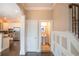 Open hallway showcases kitchen, stairs and bathroom with sleek design at 1137 Fortress Sw Ave, Atlanta, GA 30315