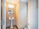Charming powder room featuring a pedestal sink, tiled floor and elegant fixtures at 1137 Fortress Sw Ave, Atlanta, GA 30315