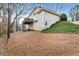 A view of the backyard of the home, with a deck and trees surrounding the property at 2205 Parliament Dr, Lawrenceville, GA 30043
