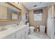 Well-lit bathroom with a large mirror over the vanity, and a shower with a shower curtain at 2205 Parliament Dr, Lawrenceville, GA 30043