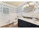 Stylish half-bath features patterned wallpaper, marble counters, and modern fixtures at 2205 Parliament Dr, Lawrenceville, GA 30043