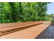 A close up of the deck with built in bench seating and four white chairs at 2205 Parliament Dr, Lawrenceville, GA 30043